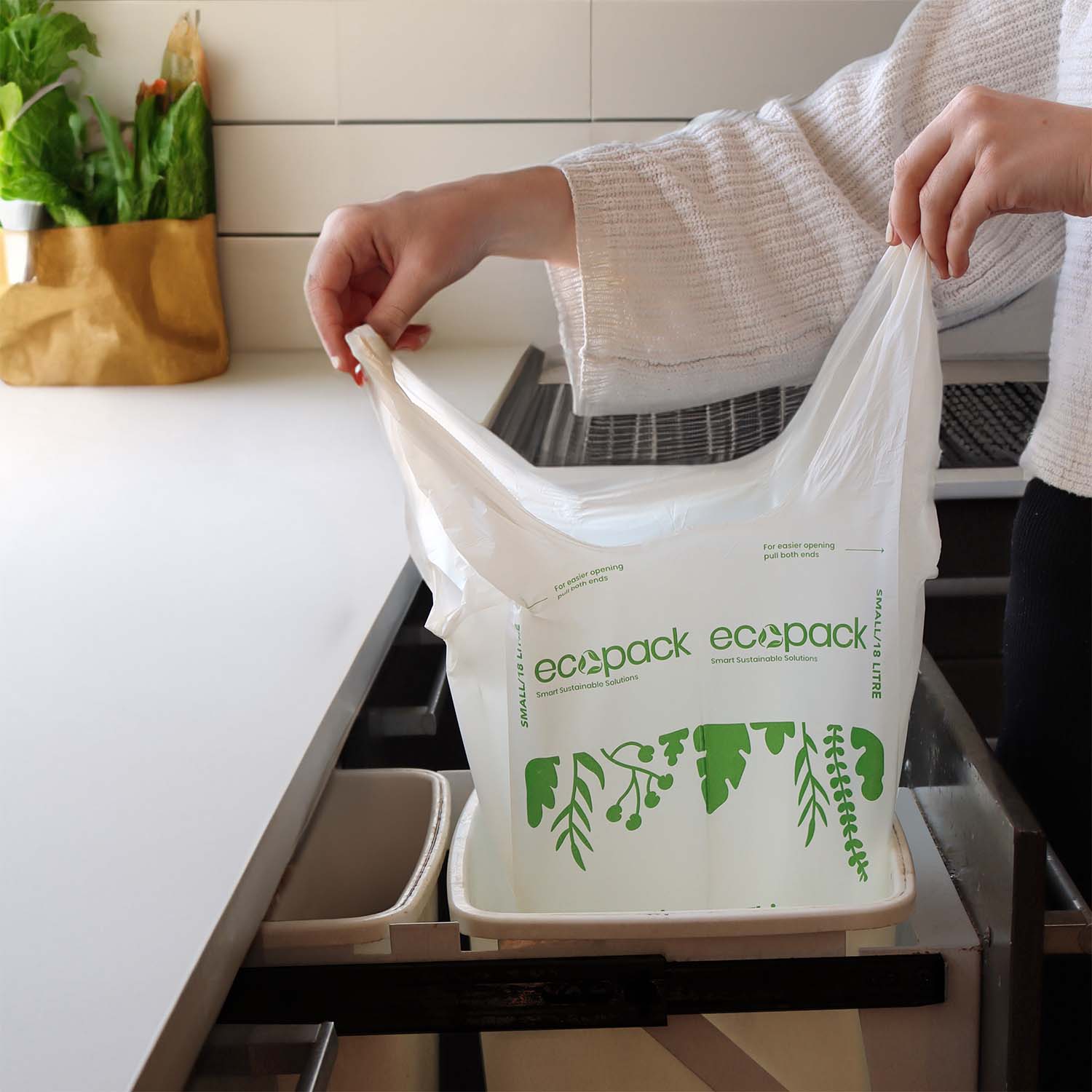 Holding the 18L Small Compostable Bin Liner in the kitchen