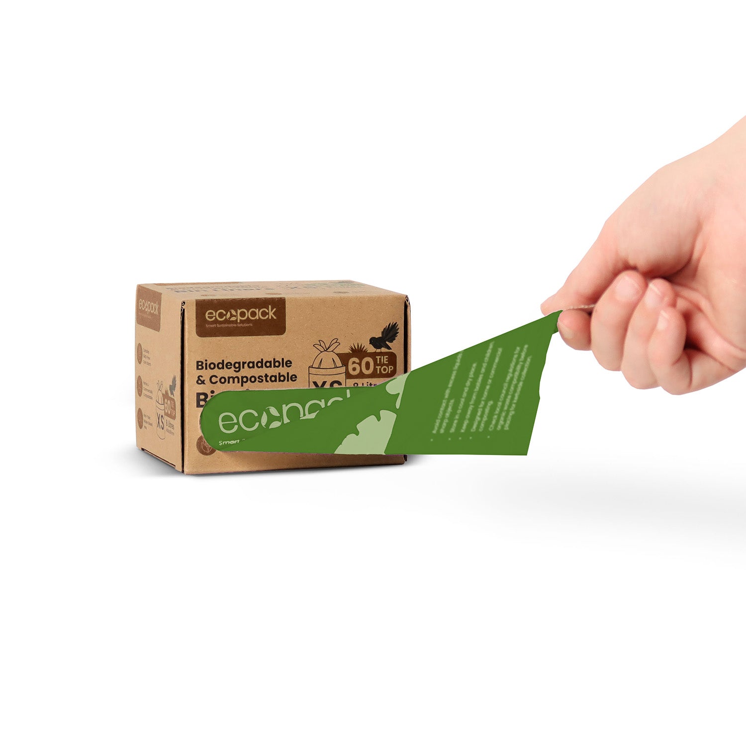 Hand holding a biodegradable and compostable label next to an eco-packaging box on a white background