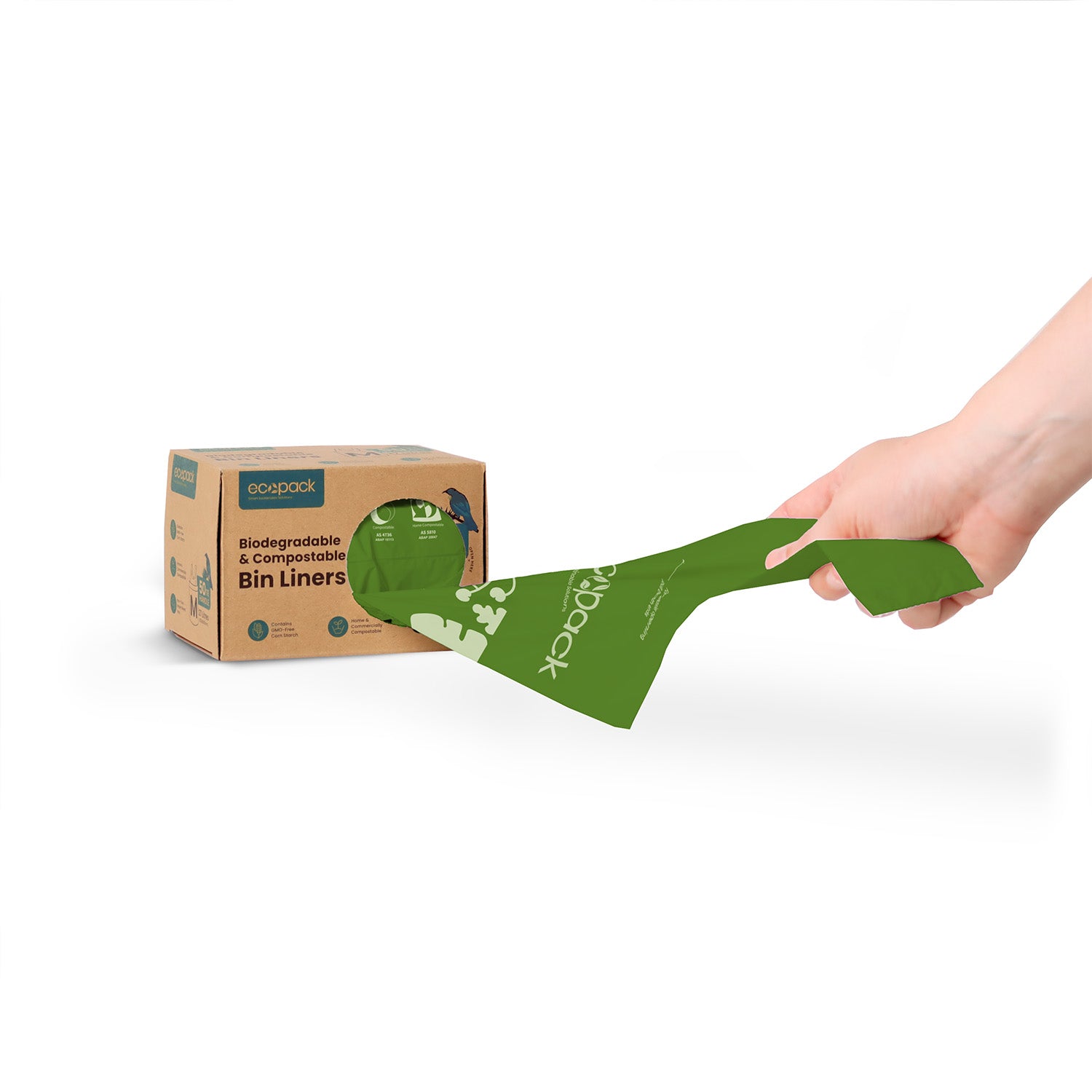 Hand holding a green compostable bin liner with a cardboard box