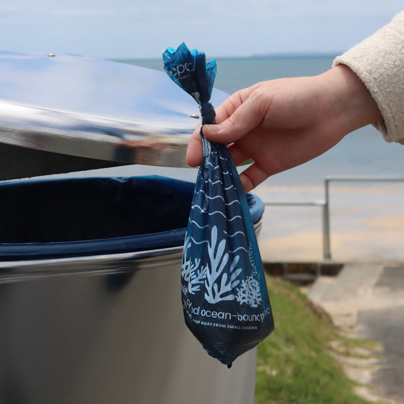 Lady throwing away Recycled Plastic Dog Poop Bag