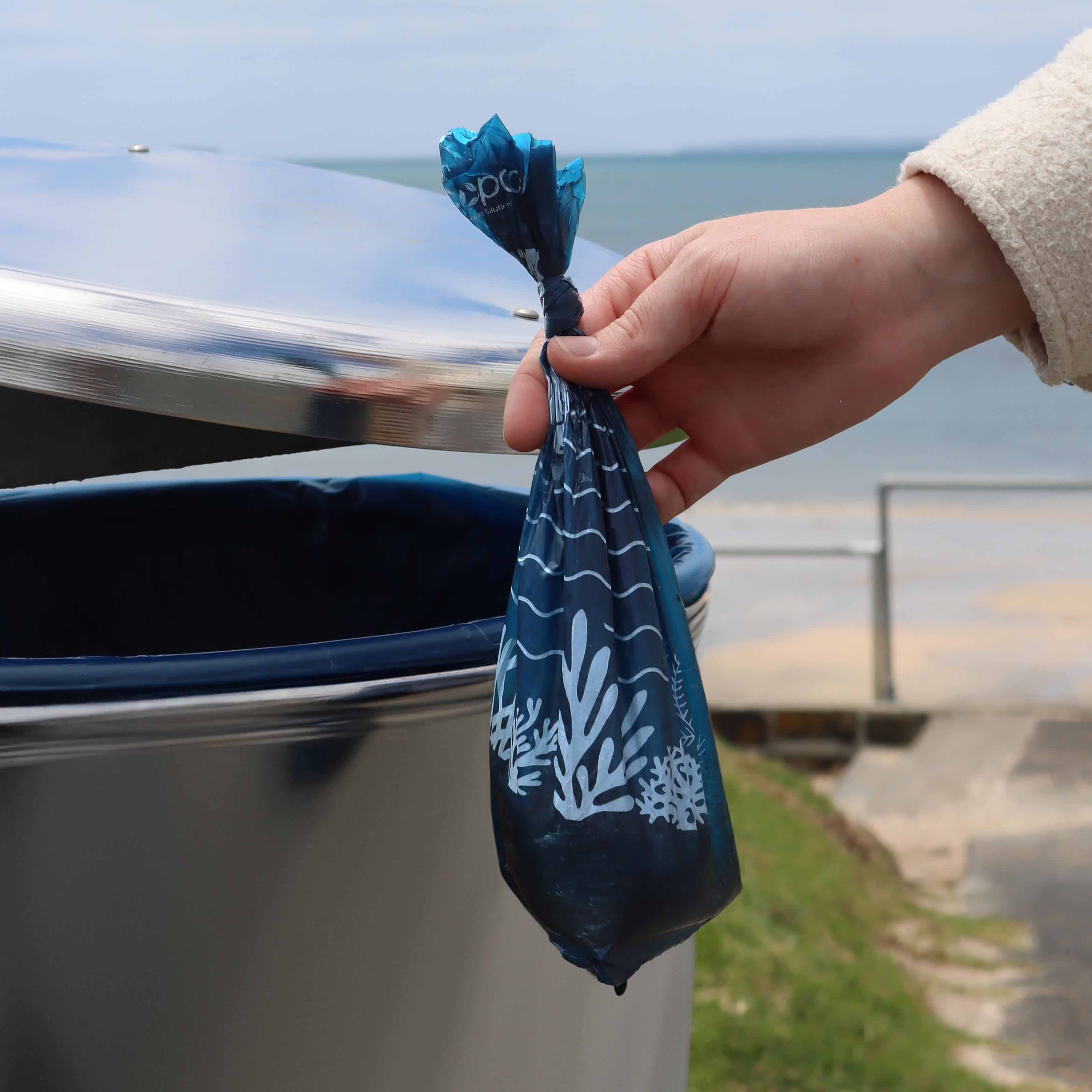 Throwing the Recycled Plastic Dog Poop Bag into the bin