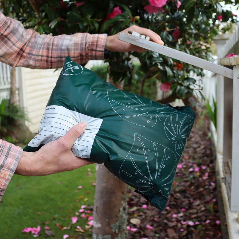 Putting Foolscap Compostable Courier Bag into mailbox