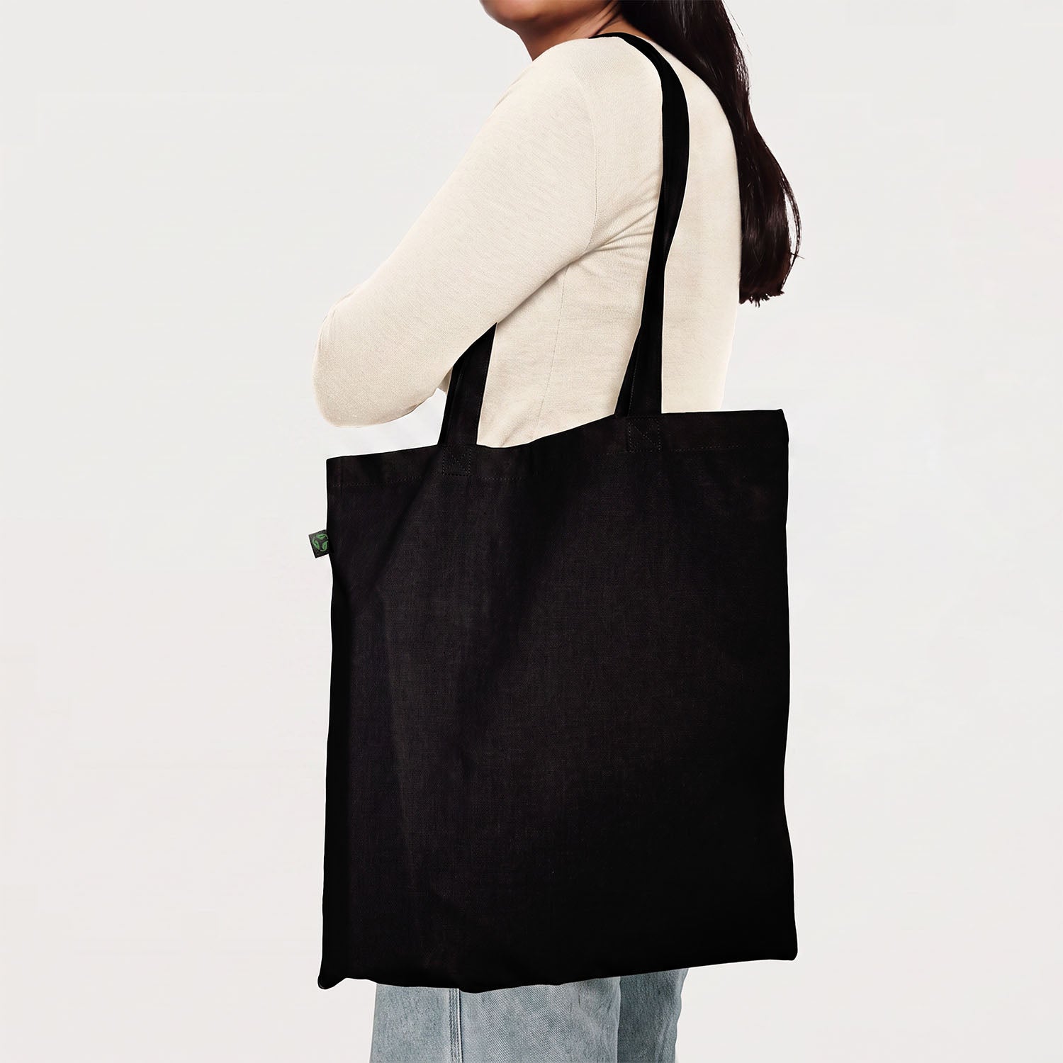 Model carrying a black calico promotional tote bag