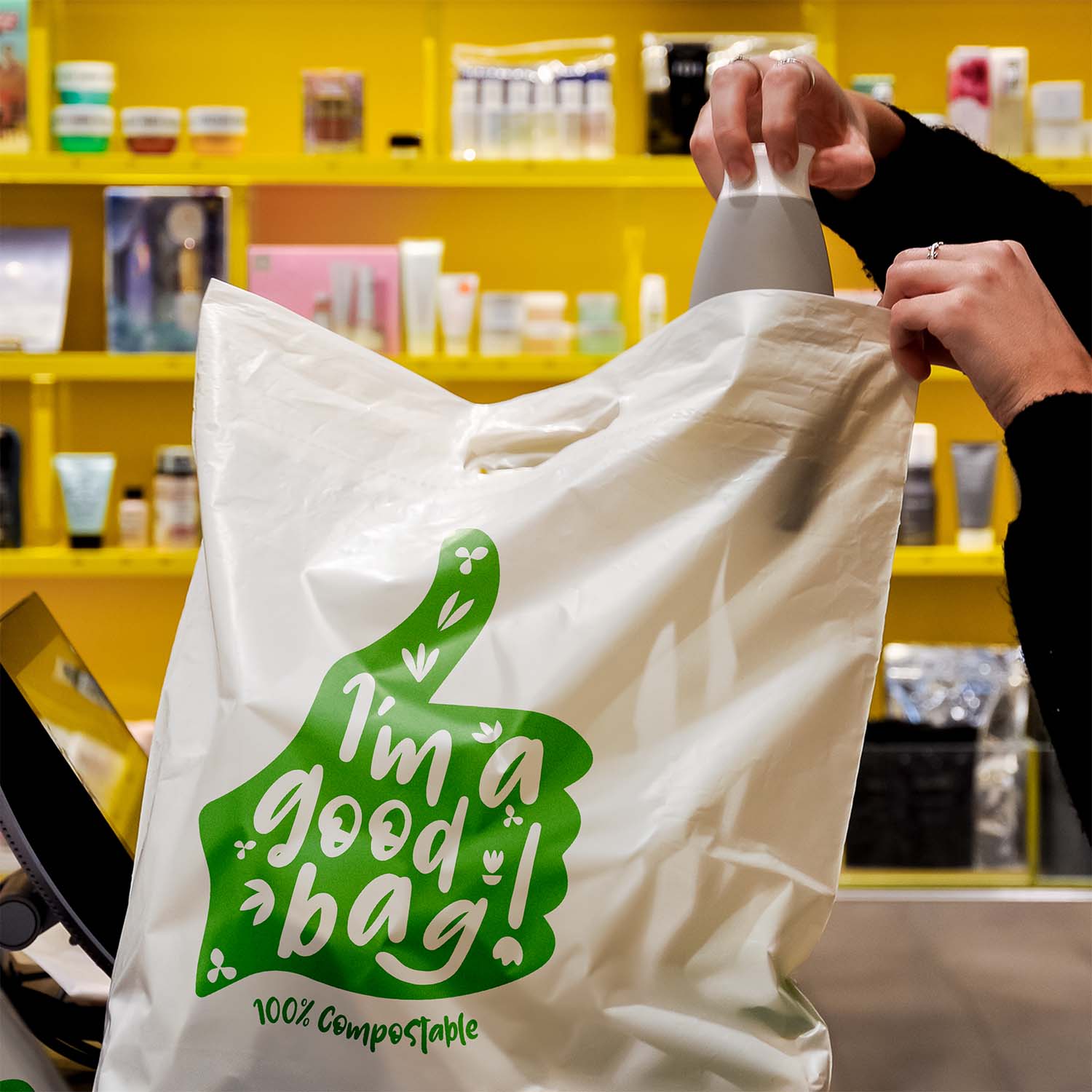 Ecopack Medium Compostable Punched Handle Retail Bag in use