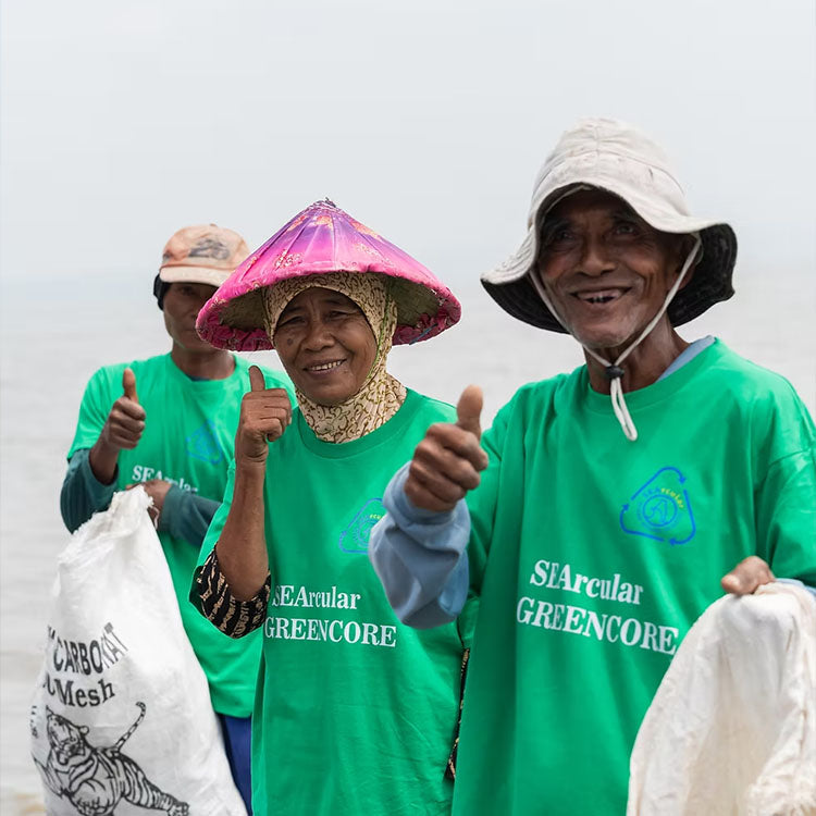 Team in green SEArcular Greencore shirts giving thumbs up