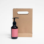 Ecopack Small Punched Out Handle Paper Bag next to a product